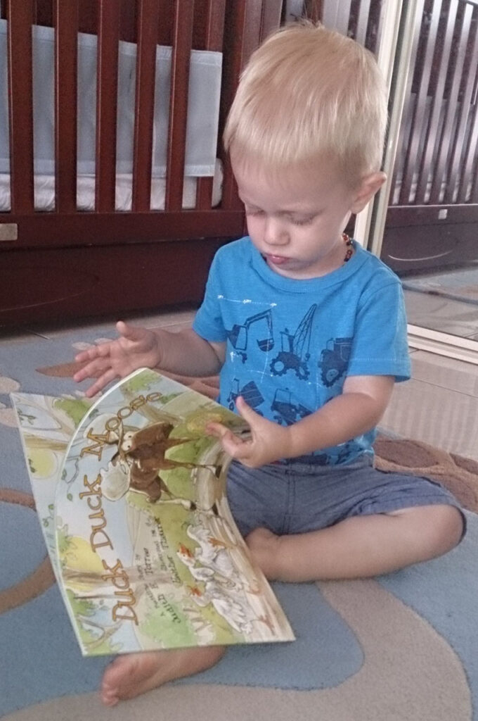 Boy Reading Duck Duck Moose